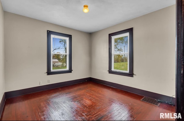 unfurnished room with dark hardwood / wood-style flooring