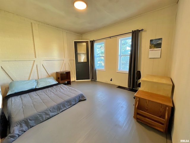 825 11th Ave S, Clinton, IA 52732 - bedroom featuring ornamental molding, wood finished floors, and a decorative wall