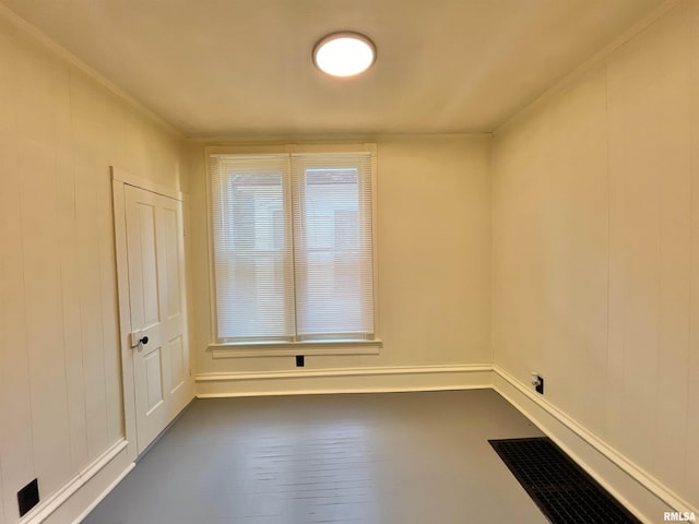 empty room with crown molding and dark wood-type flooring