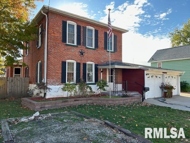 view of front of property with a garage and a front lawn