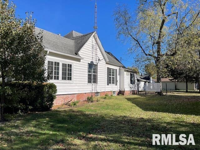 view of property exterior with a lawn