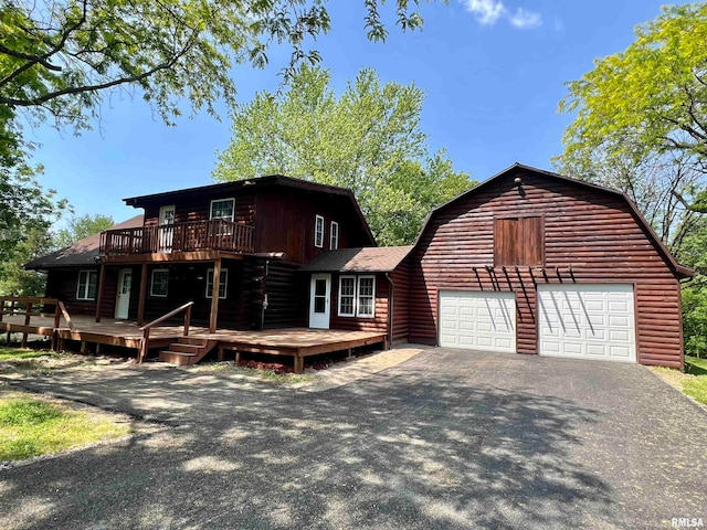 log home with a deck and a garage