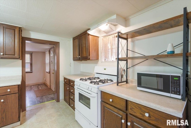 kitchen featuring light wood-type flooring and white range with gas cooktop