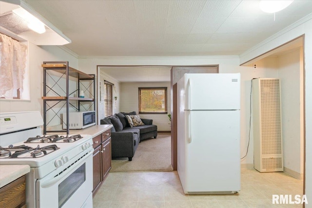 kitchen featuring light colored carpet, exhaust hood, white appliances, and ornamental molding