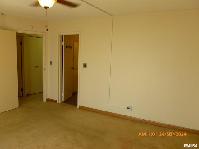 carpeted empty room featuring ceiling fan