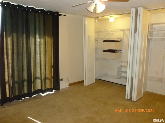 unfurnished bedroom featuring light colored carpet, a closet, and ceiling fan