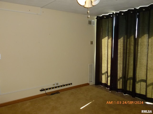 unfurnished room featuring dark carpet