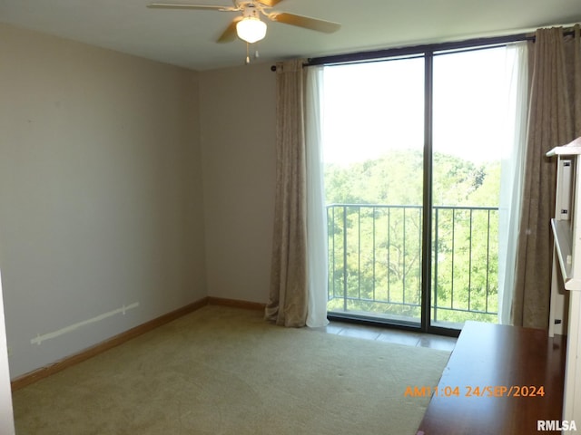 unfurnished room featuring light colored carpet and ceiling fan