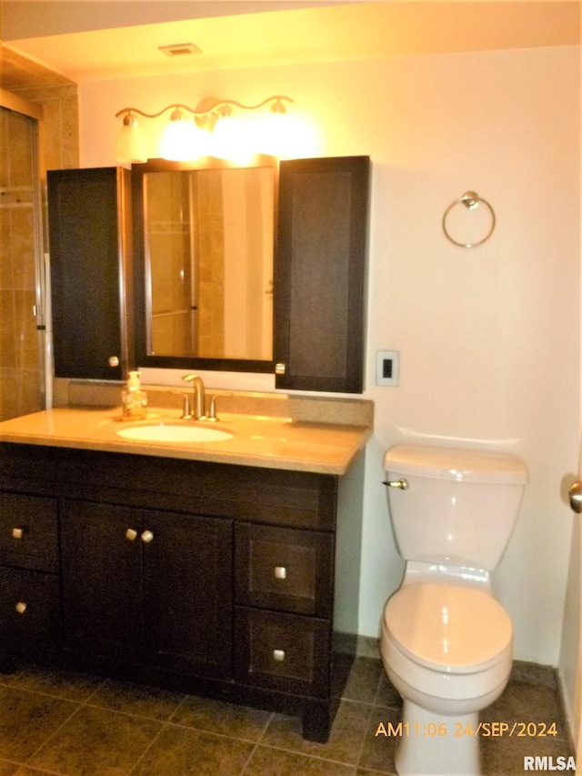 bathroom with vanity, toilet, and tile patterned flooring