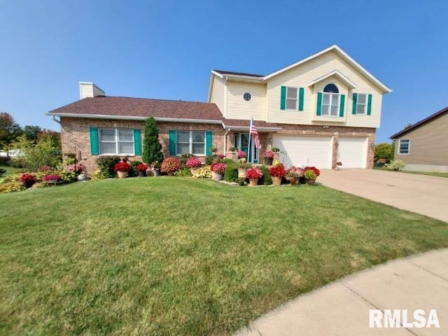 view of front of house with a garage and a front lawn