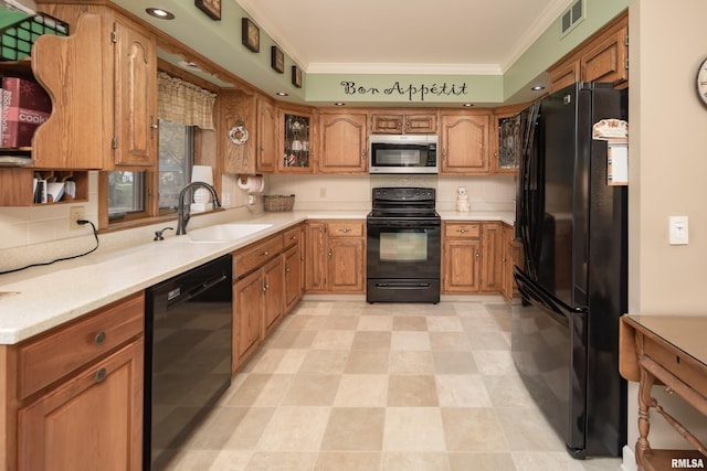 kitchen with sink, crown molding, and black appliances