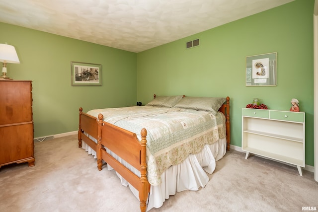 bedroom with light colored carpet