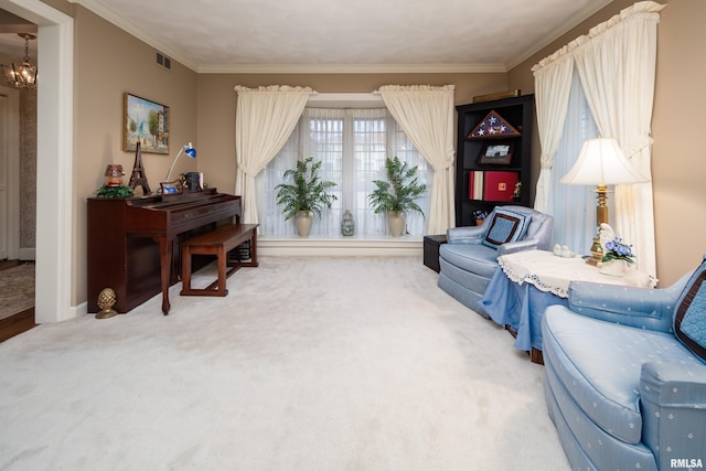 sitting room with crown molding, carpet, and a notable chandelier