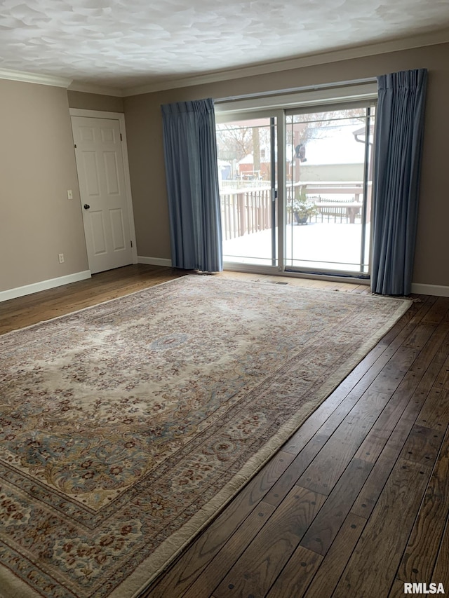 spare room featuring hardwood / wood-style floors and ornamental molding