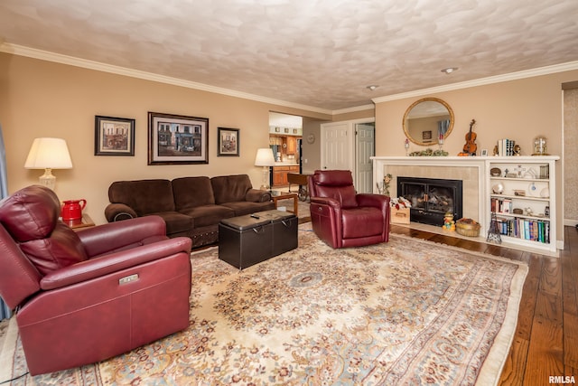 living room featuring crown molding, a fireplace, and hardwood / wood-style flooring