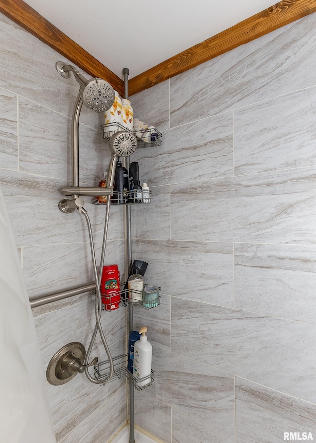 bathroom with tiled shower