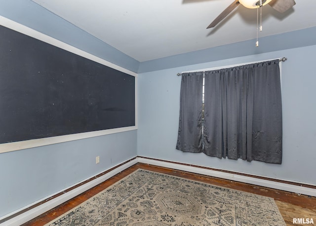 empty room with baseboard heating, ceiling fan, and wood-type flooring