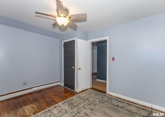 unfurnished bedroom featuring ceiling fan, wood-type flooring, and a baseboard radiator