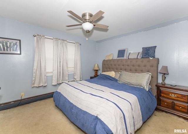 carpeted bedroom featuring ceiling fan and a baseboard heating unit