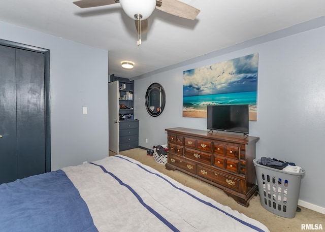 carpeted bedroom featuring ceiling fan and a closet