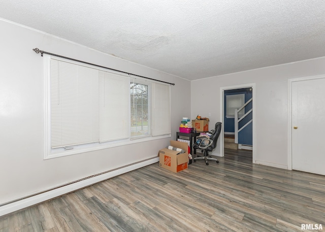 office area featuring a baseboard radiator, a textured ceiling, and hardwood / wood-style flooring