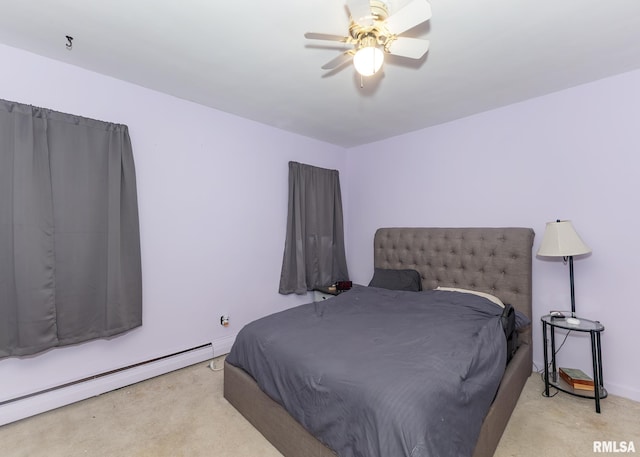 carpeted bedroom featuring baseboard heating and ceiling fan