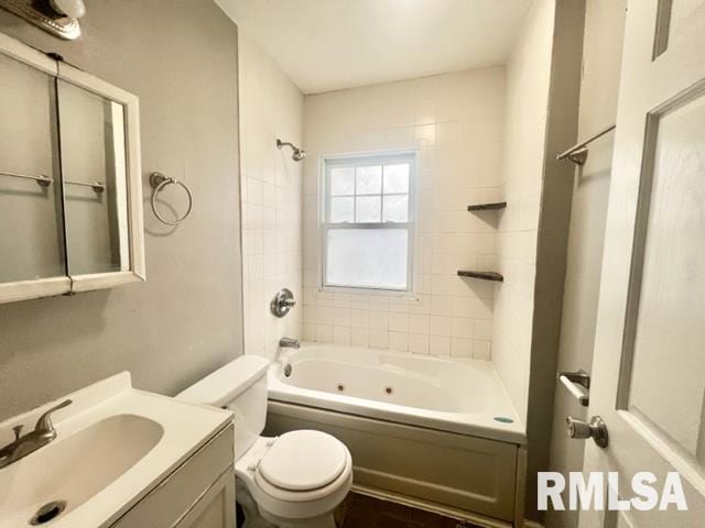 full bathroom featuring toilet, tiled shower / bath combo, and vanity