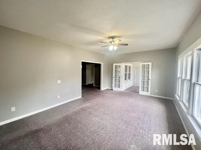 carpeted empty room featuring a textured ceiling, french doors, and ceiling fan