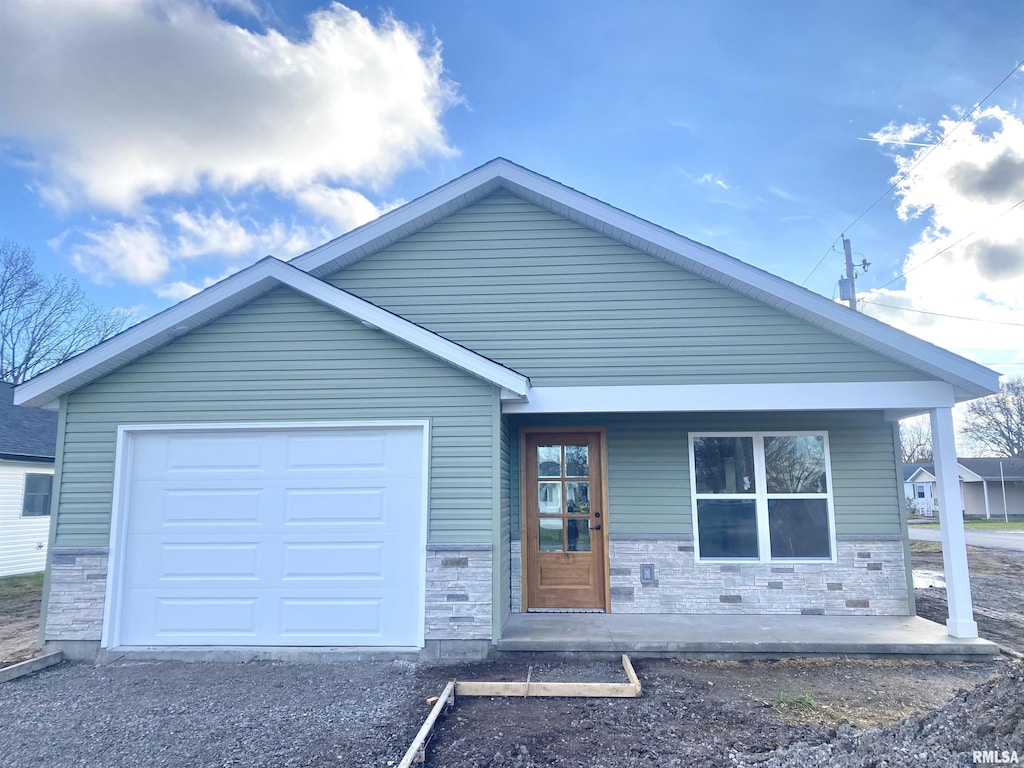 view of front facade with a porch and a garage