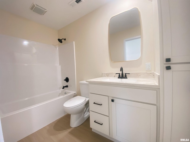 full bathroom with washtub / shower combination, wood-type flooring, vanity, and toilet