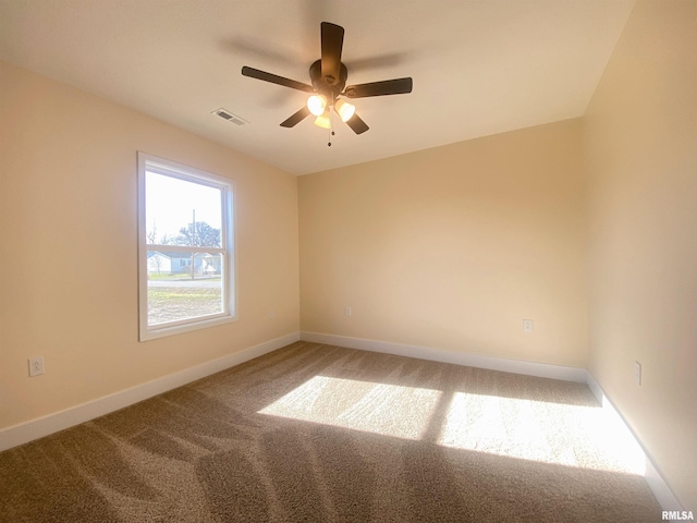 carpeted spare room with ceiling fan