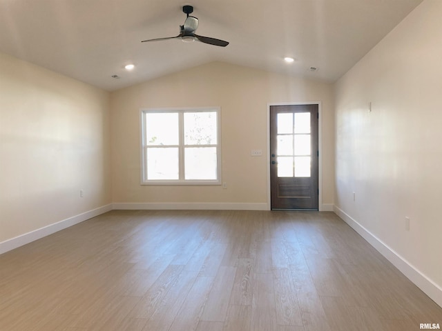 interior space with light hardwood / wood-style floors, ceiling fan, and lofted ceiling