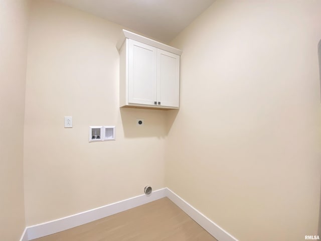 laundry area featuring electric dryer hookup, cabinets, wood-type flooring, and hookup for a washing machine