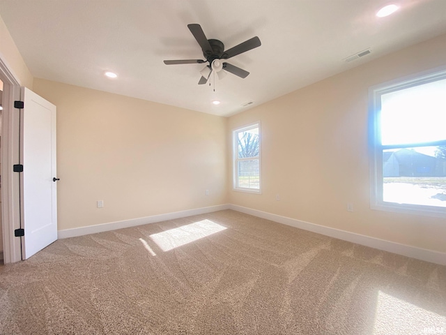 unfurnished room with carpet flooring and ceiling fan