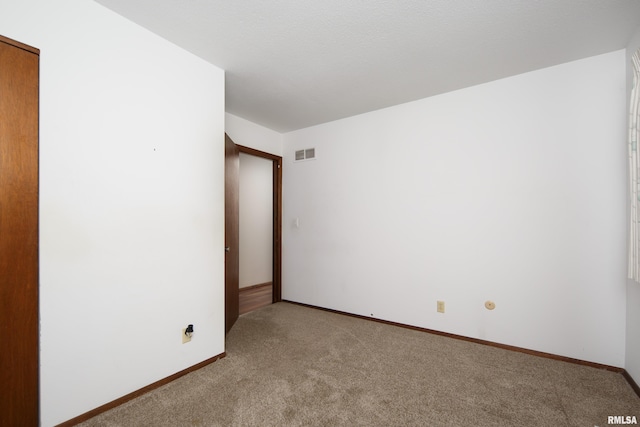 spare room with light colored carpet