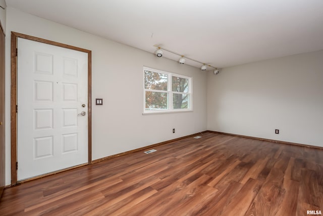 entryway with dark hardwood / wood-style flooring