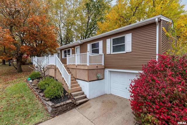 view of front of home featuring a garage and a wooden deck