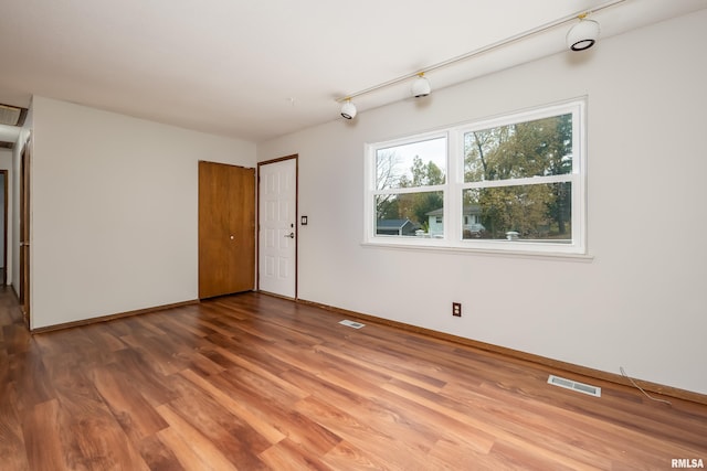 unfurnished room featuring hardwood / wood-style flooring