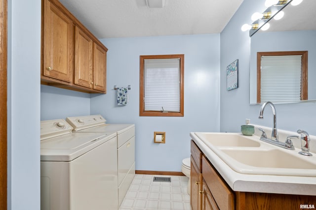 laundry area with washer and clothes dryer, sink, and a textured ceiling