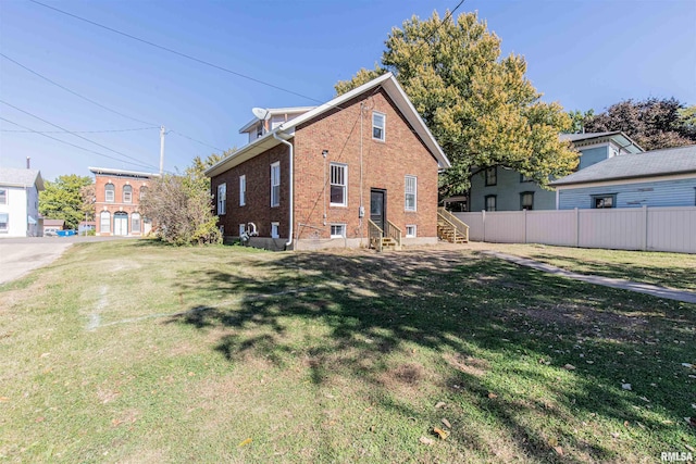 view of side of property featuring a yard