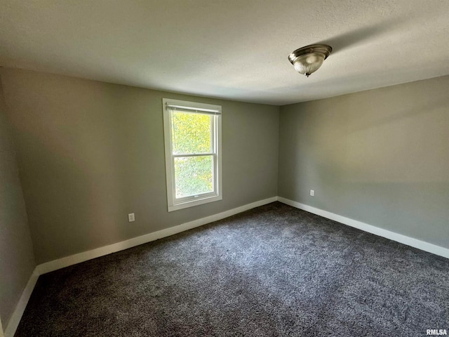 carpeted spare room featuring a textured ceiling