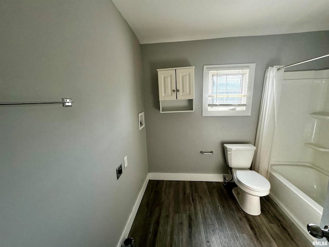 bathroom featuring shower / bath combo with shower curtain, wood-type flooring, and toilet