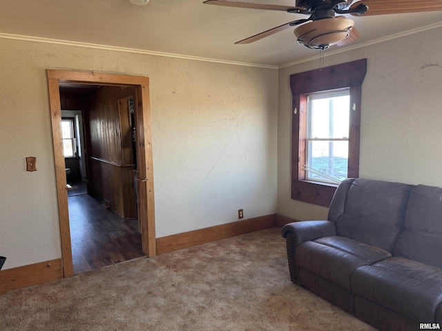 unfurnished room featuring crown molding, ceiling fan, and dark carpet