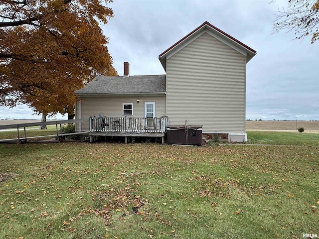 back of property featuring a yard and a wooden deck