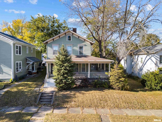 view of front of home with covered porch and a front lawn