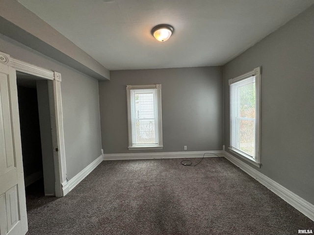 carpeted empty room with a healthy amount of sunlight