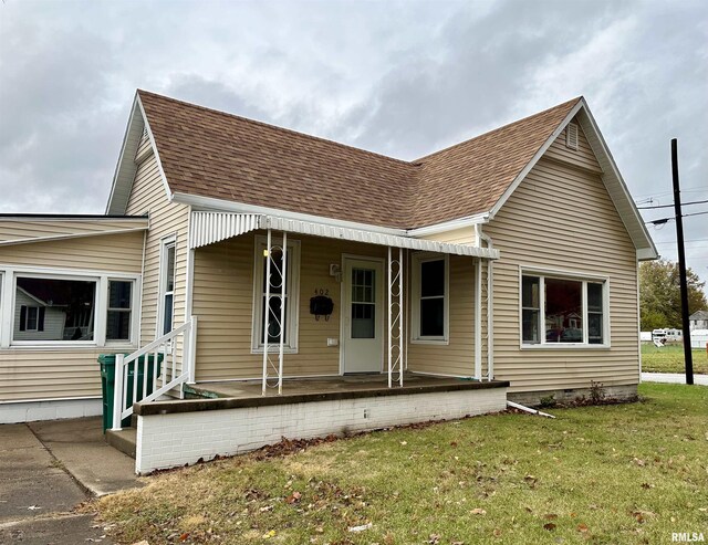 view of front of house with a front yard and a porch