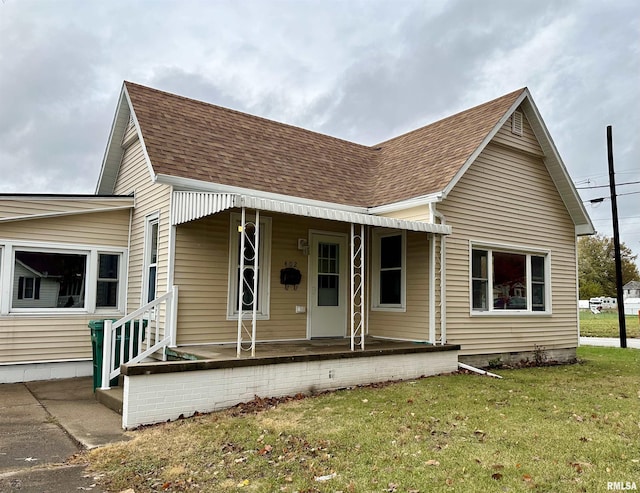 view of front of house with a front yard and a porch