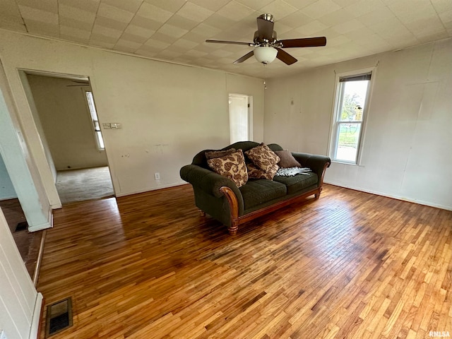 living room with hardwood / wood-style flooring and ceiling fan