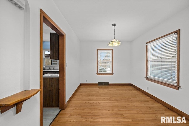 dining room featuring light hardwood / wood-style floors and an inviting chandelier